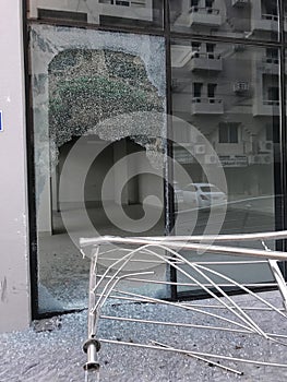 Somebody broke toughened glass partition for stealing the things from an commercial shopping center