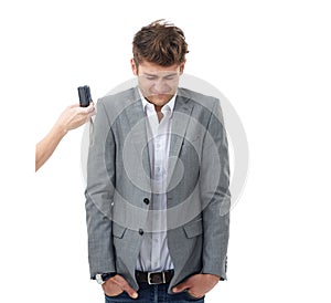 Somebody is shy. Studio shot of a young man wincing in front of a camera isolated on white. photo