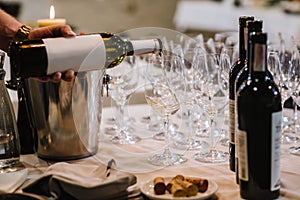 A somelier pours wine into the glass at the restaurant