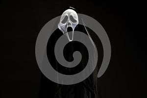 Someone in black cover with white ghost mask cosplay to devil ac