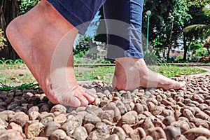 Someone is doing foot therapy on rocks photo