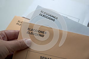 Someone holding a couple of envelopes to vote photo