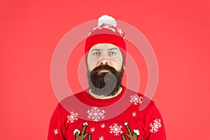 Someone stole christmas. upset because santa delay. has no present. serious hipster red background. bearded man knitted