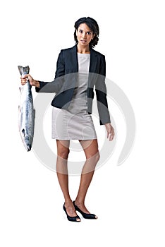 Somethings fishy here.... - Suspicious business deals. Studio shot of a businesswoman holding a dead fish against a
