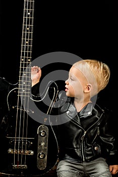 Sometimes music is all you need. Rock and roll music performer. Adorable music fan. Small musician. Little rock star