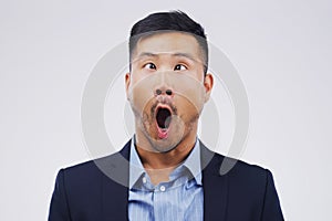 Sometimes nonsense makes the best sense. Studio shot of a young man making a funny face against a gray background.