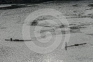 Two fishermen on bamboo boats fishing in the dawn