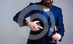 Sommelier man, degustator, winery, male winemaker. Bottle, red wine glass. Beard man, bearded, sommelier, tasting