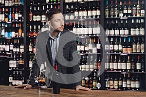 Sommelier man is preparing for tasting of red wine in restaurant