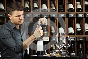 Sommelier opening red wine bottle with corckcrew