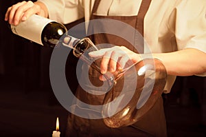 A sommelier opening wine bottle