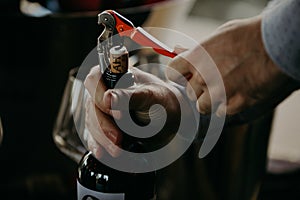 Sommelier opening wine bottle in the wine cellar
