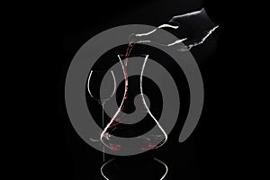 Sommelier pour out red wine from bottle to decanter