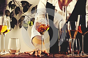 Sommelier pouring rose wine into glass at wine tasting in winery, bar or restaurant. White background