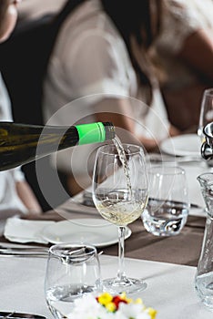 Sommelier pouring wine into glass at wine and food tasting