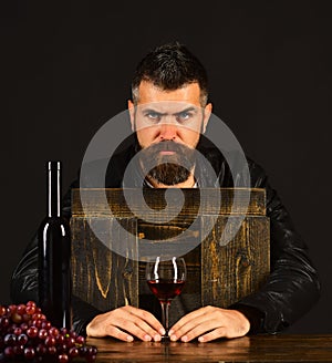 Sommelier tastes drink. Degustator with strict face holds wine glass