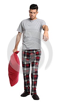 Somnambulist with red pillow on white background. Sleepwalking