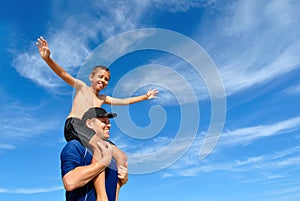 Son balancing on dad's shoulders