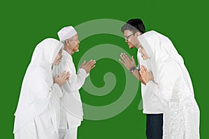 Son and daughter greetings their parents during Eid al-fitr celebration in studio