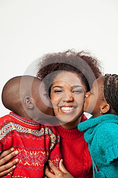 Son and daughter kissing her mother