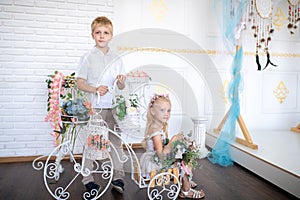 Son and daughter in a white room