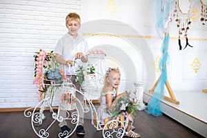 Son and daughter in a white room