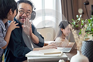 Son disturbs father while working.