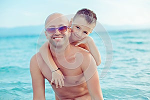 Son embraces his father on the beach