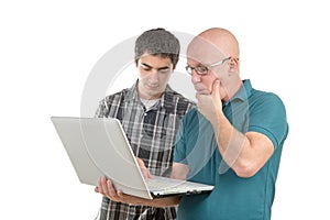 A son explains to his father the laptop