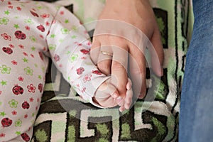 Son and father, baby holding dads finger. Family concept