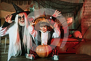 Son and father with carve pumpkins for Halloween. Grandpa and grandson with pumpkin together as preparation for