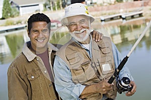 Son With Father Holding A Fishing Rod