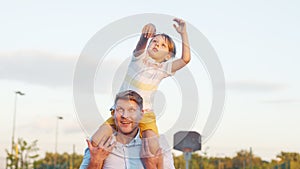 Son on father`s shoulders outdoors