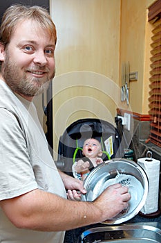 Son and father washing dishes.