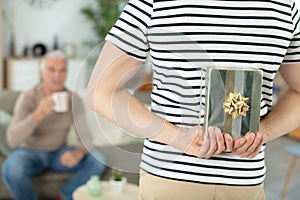 son giving present to senior dad