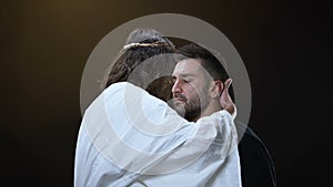 Son of God hugging crying male, sins forgiveness, soul salvation, religious love