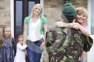 Son Greeting Military Father On Leave At Home