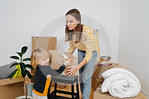 Son helping mother to pack, they are moving out from an old apartment