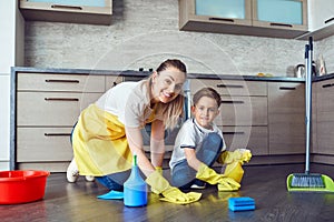 Son helps mom clean up in the kitchen.