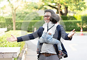 A son hug his father and smile with casual suit in the park