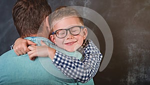 Son hugging his dad. caring dad foster parent give support his child boy. single father holding son in hands and photo