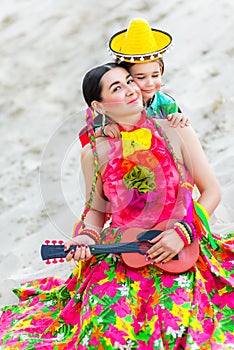 Son hugging his mother in Mexican costume and