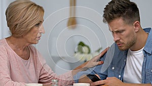 Son ignoring live communication with mother, chatting on smartphone, conflict