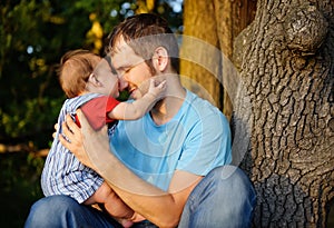 Son kissing his father