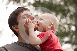 Son kissing his father