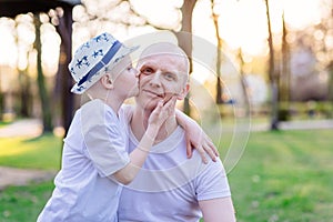 Son kissing his father. Father`s Day.