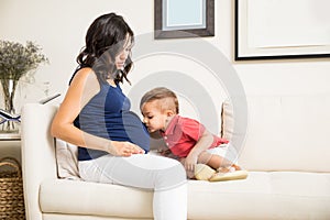 Son Kissing Mum`s Pregnant Belly At Home