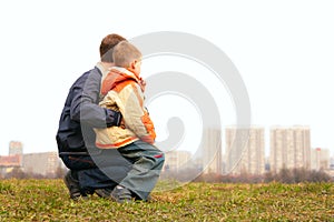 Son on lap of father outdoor