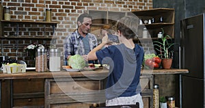 Son making video of happy family in kitchen cooking food happy smiling preparing meal together