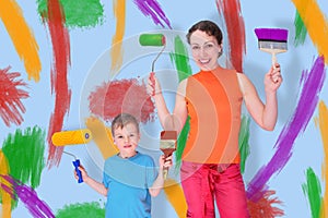 Son and mother draw with rollers and brushes photo